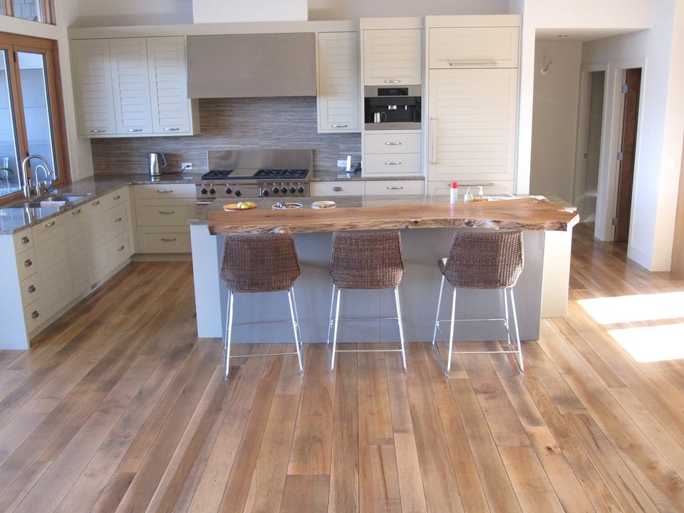 Newly sanded and finished hardwood flooring in a residential room